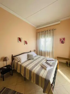 a bedroom with a large bed in a room at Bayside Apt. in Souda
