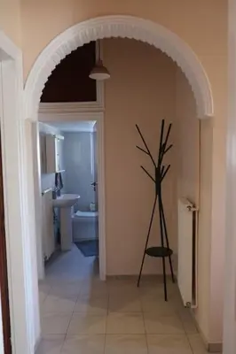 a hallway with an archway with a plant in it at Bayside Apt. in Souda
