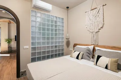 a bedroom with a bed and a large window at Raviewha Luxury Apartments in Ravdhoúkha