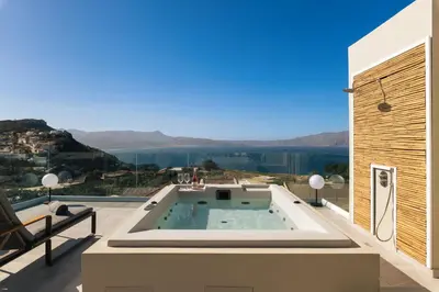 a villa with a swimming pool on a roof at Raviewha Luxury Apartments in Ravdhoúkha