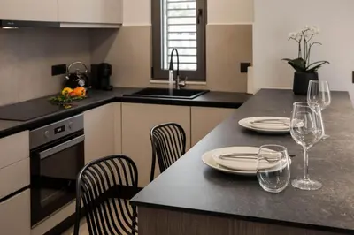 a kitchen with a table with plates and wine glasses at Chania Elegance Suites in Chania Town