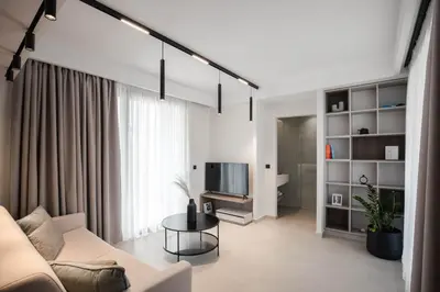 a living room with a white couch and a table at Chania Elegance Suites in Chania Town