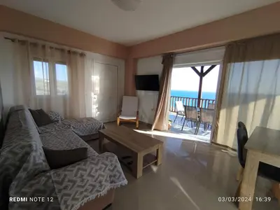 a living room with a couch and a table at Votsalo House in Khóra Sfakíon