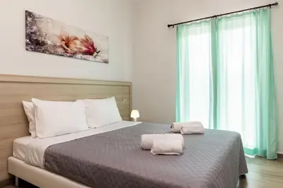 a bedroom with a bed with two towels on it at Kyril Apartment in Chania Town