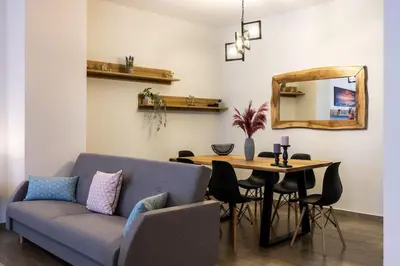 a living room with a couch and a table with a mirror at Kyril Apartment in Chania Town