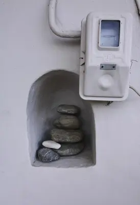 a wall with three rocks and a soap dispenser at Casa Vista in Kissamos