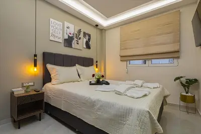 a bedroom with a large bed with two white pillows at Nicole Studio in Center Chania in Chania Town