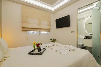 a bedroom with a bed with a tray with flowers on it at Nicole Studio in Center Chania in Chania Town