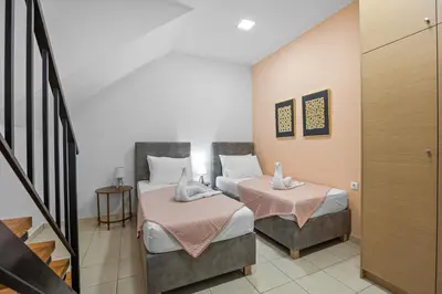 a hotel room with two beds and a staircase at CasaParadiso in Perivólia