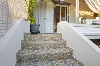 a set of stairs leading to the front door of a house at CasaParadiso in Perivólia