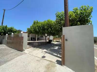 a white refrigerator in front of a house at Olivia House -BY APOKORNAS VILLAS in Káïna