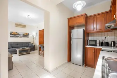 a kitchen and living room with a stainless steel refrigerator at Sofie's Garden View Apartment in Daratso