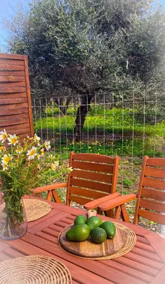 a wooden table with a plate of limes on it at NICOL's HOUSE in Chania Town