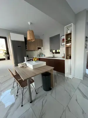 a kitchen with a wooden table and a sink at Luxury Sunset Villa with Private Pool & Sea Views in Kalyves