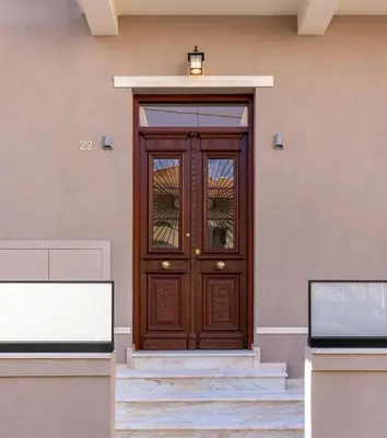 a wooden door on the side of a building at The Owl House near Chania City Centre in Chania Town