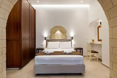 a bedroom with a large bed in a room at The Owl House near Chania City Centre in Chania Town