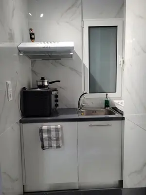 a small kitchen with a sink and a mirror at Cretan Dream in Chania Town