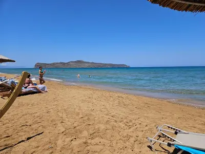 a group of people sitting on the beach at Cretan Dream in Chania Town