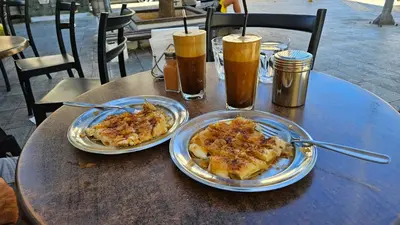 two plates of food on a table with drinks at Cretan Dream in Chania Town