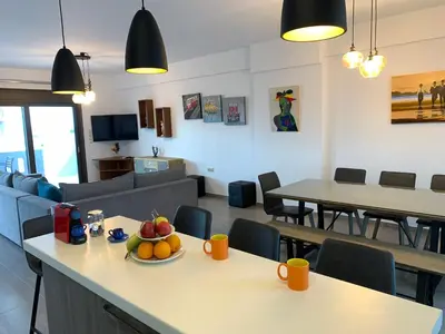 a living room with a table with a bowl of fruit on it at Angela Apartments in Kato Daratso