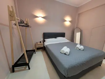 a bedroom with a bed with two towels on it at Friday's House in Chania Town
