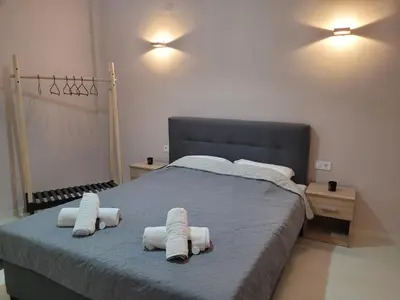a bedroom with a bed with towels on it at Friday's House in Chania Town