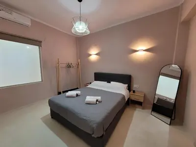 a bedroom with a bed with two towels on it at Friday's House in Chania Town