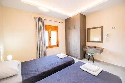 a bedroom with two beds and a mirror at Aspro Apartments in Koprána