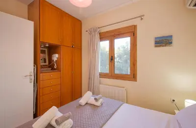 a bedroom with a bed with two towels on it at Aspro Apartments in Koprána