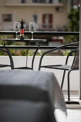 a table with two glasses and a bottle of wine at Dimitris City Break Apts in Chania Town