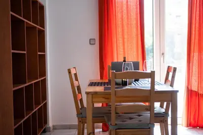 a dining room with a table and chairs and a window at Dimitris City Break Apts in Chania Town