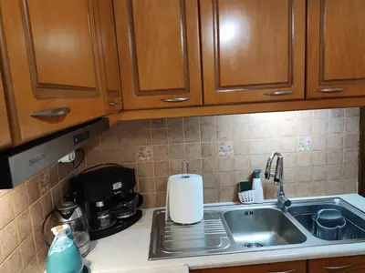 a kitchen counter with a sink and aounterpectropheropheropheropheropherophe at Georgia apartment in Chania Town