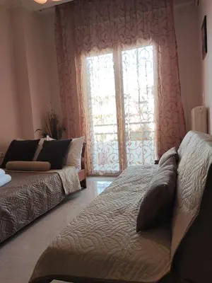 a living room with a couch and a window at Georgia apartment in Chania Town