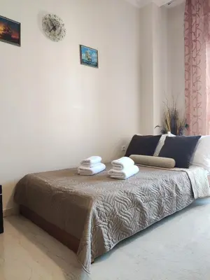a bedroom with a bed with two towels on it at Georgia apartment in Chania Town