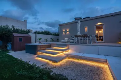 a backyard with a patio with stairs and lights at Christini Secrets in Plátanos