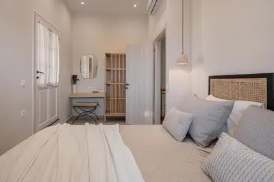 a white bedroom with a bed and a desk at Casa Benedetta in Chania Town