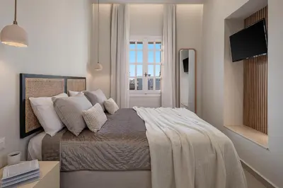 a bedroom with a bed with pillows and a window at Casa Benedetta in Chania Town