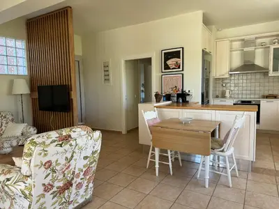 a kitchen and living room with a table and chairs at Primavera Retreat in Chania Town
