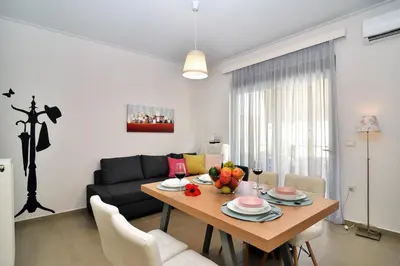 a living room with a table and a couch at Cosy apartment near the beach in Chania Town