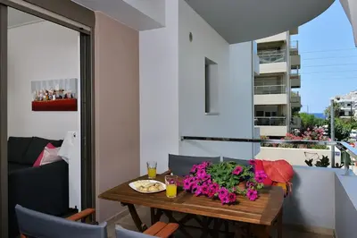 a table with flowers on it in a living room at Cosy apartment near the beach in Chania Town