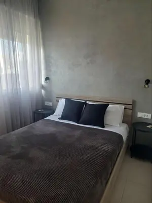 a bedroom with a large bed with blue pillows at Kidonias apartment in Chania Town