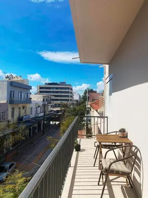 a balcony with a table and a view of a street at Kidonias apartment in Chania Town