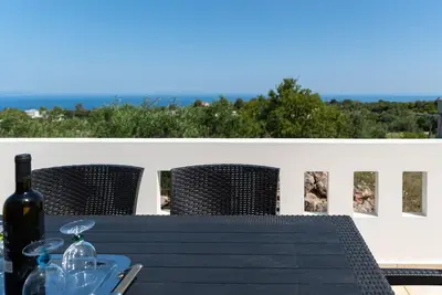 a black table with a bottle of wine on it at Bella Vista Casa in Chania Town