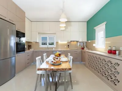a kitchen with a table and chairs in a kitchen at Olive Grove Apartment in Chania Town