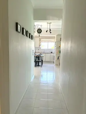 a hallway with white walls and a white tile floor at Stylish house 2 min from the beach! VERY FAST WF in Daratso