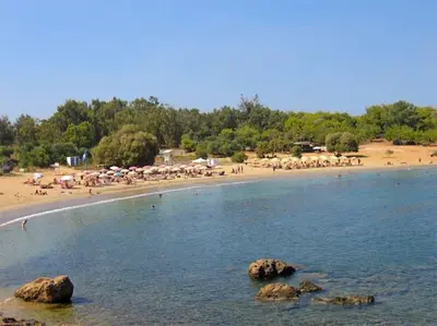 a group of people on a beach with rocks in the water at Stylish house 2 min from the beach! VERY FAST WF in Daratso