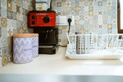 a counter top with a coffee maker and a toaster at Xanthippi's in Pemónia