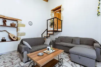 a living room with two couches and a coffee table at Xanthippi's in Pemónia