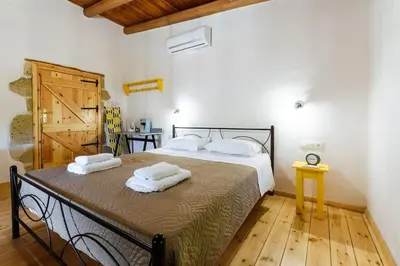 a bedroom with a bed with two towels on it at Xanthippi's in Pemónia