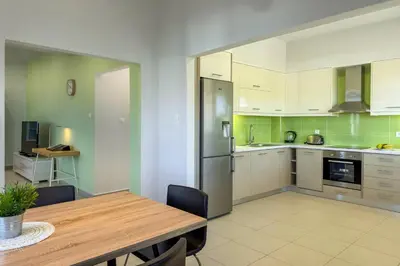 a kitchen with a wooden table and a dining room at Villa Adam in Chania Town